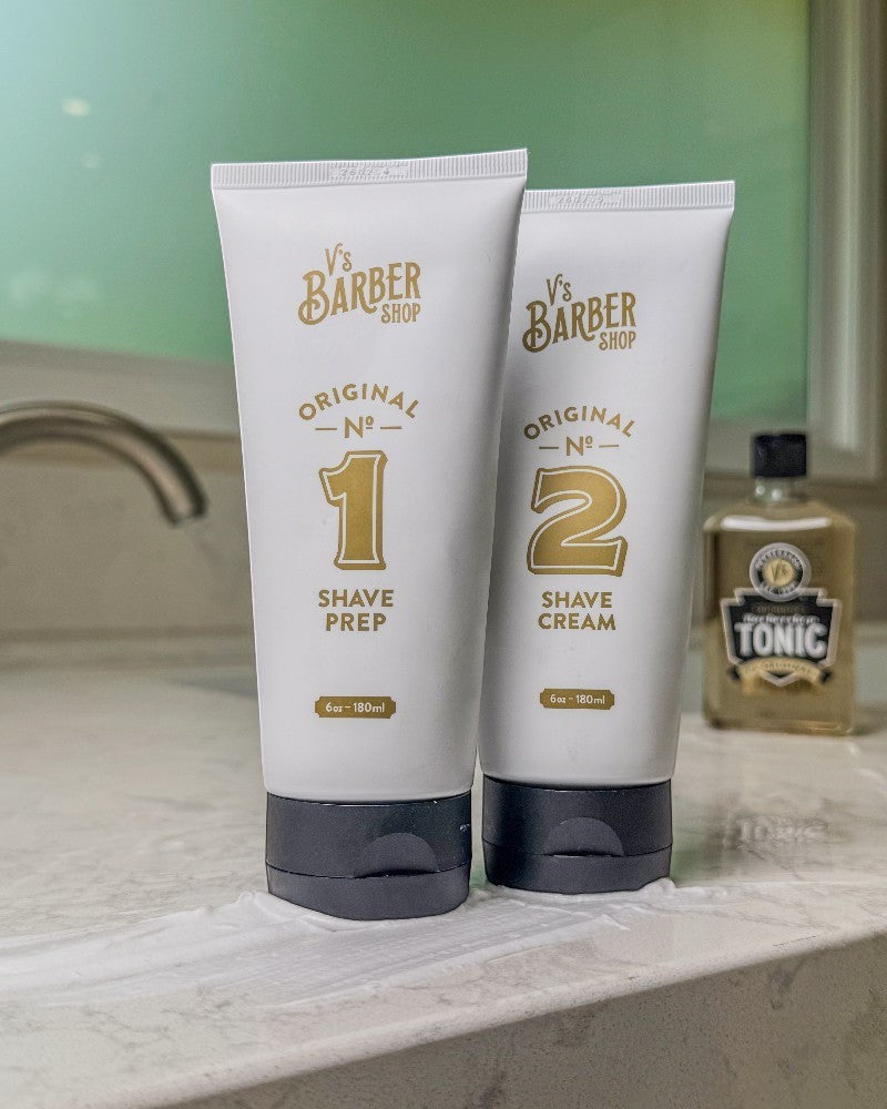 V's Barbershop Original No. 1 Shave Prep and No. 2 Shave Cream tubes on a bathroom counter.